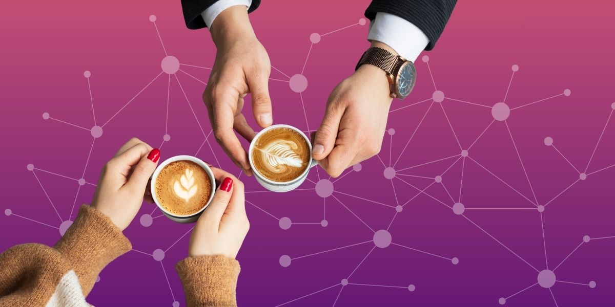 two people with coffees in their hands, representing meeting in person